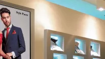 Digital display featuring models in a clothing store