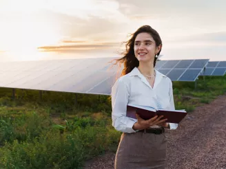 female investor in front of solar power plant