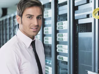 A man standing by computer servers