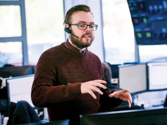 Man stood talking to someone using a headset