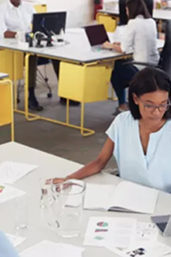 business office with people working a laptops